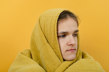 Guy wapped in the blanket looking sideways