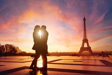Paris, couple in love kissing near Eiffel tower, France