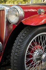 red vintage car with spoke wheel