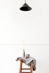 Vase of gypsophila flower on a wooden stool in a white room