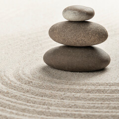 Obraz na płótnie Canvas Stacked zen stones sand background art of balance concept