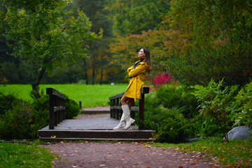 A girl in bright clothes in an autumn park