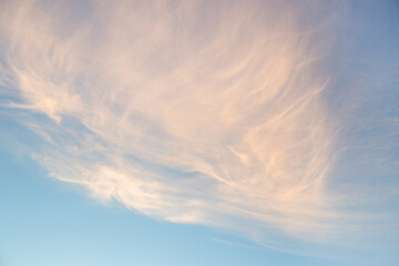 Obraz premium Clouds construction in sunset under blue sky.