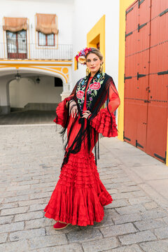 Female flamenco artist standing at Plaza de toros de la Real Maestranza de Caballeria de Sevilla, Spain