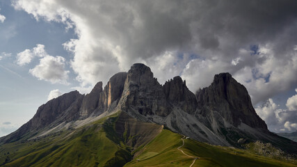Sassolungo near Sella Pass in Dolomites, Italy with dramatic stormy clouds in the afternoon, muted, natural colors