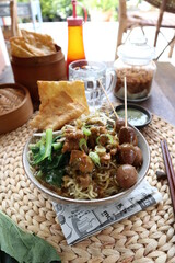 Homemade noodles with chicken and vegetables topped with boiled quail eggs
