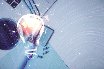 Bulb drawing over computer on the desktop background. Top view. Double exposure. Idea concept.