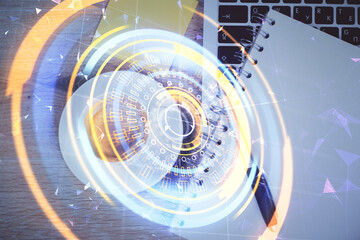 Obraz premium Technology hologram drawing over computer on the desktop background. Top view. Double exposure. Tech concept.