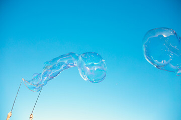 Big soap bubbles in sunset.
