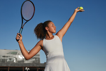 Confident black tennis player with racket and ball