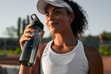Tennis player with bottle of water