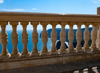 Beautiful old elegant balustrade made of white marble with dusty railings against the background of...