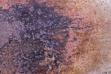 Close-up of a old rusty grunge red brown purple iron background texture with scratches and cracks. Detail of a old rusty electric tailor iron or flatiron surface. Macro.