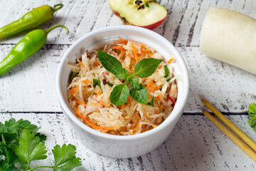 Daikon white radish salad with carrots and apples. Healthy eating