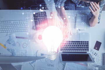Double exposure of man and woman working together and bulb drawing. Computer background. Top View. Idea concept.