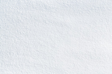 Natural snow texture. Smooth surface of clean fresh snow. Snowy ground. Winter background with snow patterns. Perfect for Christmas and New Year design. Closeup top view.