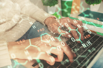 Double exposure of woman hands typing on computer and formula hologram drawing. Education concept.