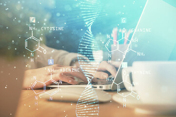 Double exposure of woman hands typing on computer and DNA hologram drawing. Medical education...