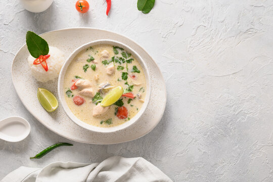 Spicy Creamy Coconut Tom Kha Gai Soup With Chicken, Cherry Tomato, Coconut Milk, Kaffir, Galangal, Lemongrass,mushrooms. Asian Thai Food. Coconut Chicken Soup. View From Above. Copy Space.