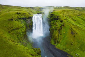 Aerial drone view of Skogafoss waterfall in Iceland, one of the most famous tourist visited attraction and landmark