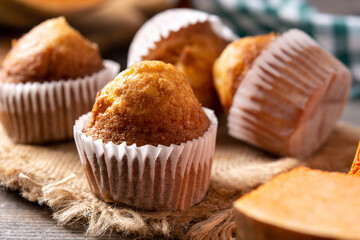 Pumpkin muffins on wooden table	