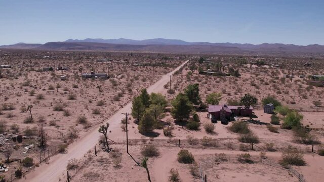 Joshua Tree California Dirt road with houses in desert. Aerial view - stock video