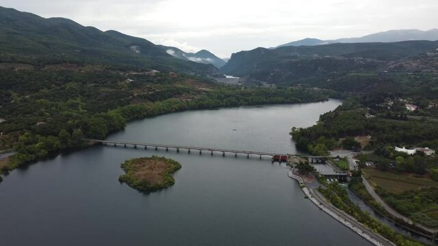 Haliacmon river aerial view. Overcast day with clouds. Bridge and small island