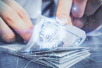Double exposure of technology drawing hologram and us dollars bills and man hands. Data concept