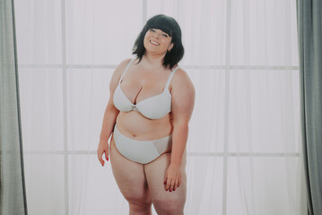 Body acceptance concept.  curvy girl posing in studio against society prejudice
