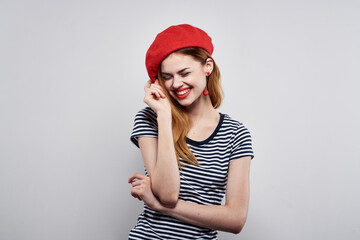 pretty woman in a striped t-shirt red lips gesture with his hands isolated background