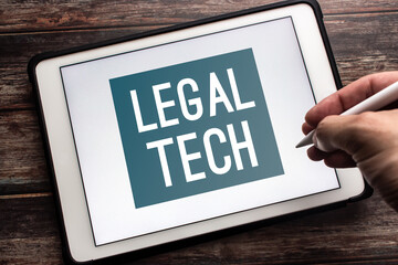 Closeup keyword Legal Tech (Legal technology) on tablet. Technology and software to provide legal...