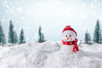 Christmas background with happy snowman standing in winter landscape. Christmas greeting card. Winter time.