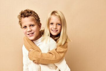 brother and sister together in sweaters fun casual wear Studio Lifestyle