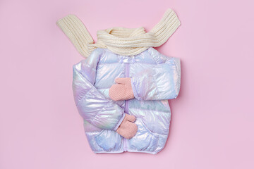 Kids warm puffer jacket with scarf  on pink background. Stylish childrens outerwear. Winter fashion outfit © igishevamaria