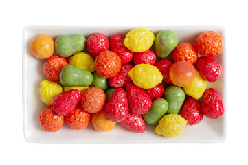 Chewing colorful gum in the form of fruit on a plate isolated on white background. The top view