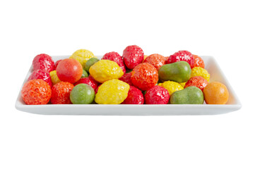 Chewing colorful gum in the form of fruit on a plate isolated on white background. Close up