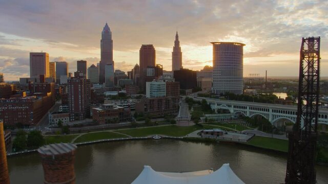 Beautiful early morning rising drone shot of downtown Cleveland Ohio to reveal sunrise behind city skyline