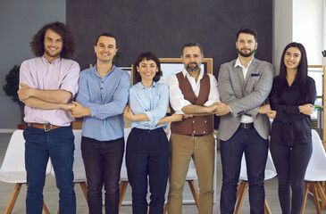 Young smiling office colleagues hold hands in a chain, happy colleagues, the concept of friendly...
