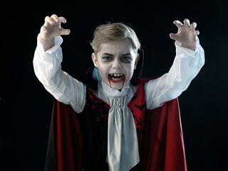 Boy in Halloween vampire makeup costume