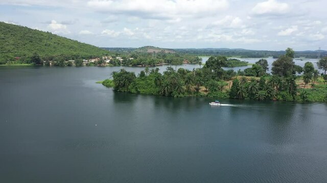 Aerial Adome boat on Volta River island Ghana Africa. River system in  West African country of Ghana. Adome Bridge crosses the river. Akosombo Dam forms largest manmade lake by area in the world.
