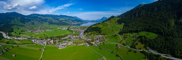 Fototapeta na wymiar Aerial view of the city Giswil beside the the lake Sarnen in Switzerland on a sunny day in summer. 