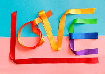 Banner with the word LOVE in large letters made with rainbow-colored fabrics