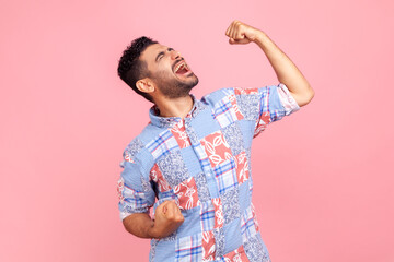 Portrait of happy screaming handsome bearded man in blue casual style shirt standing with excited...