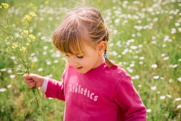 little blondie girl picking flowers