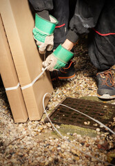 Man unpacking folded boxes with racks on summer cottage backyard