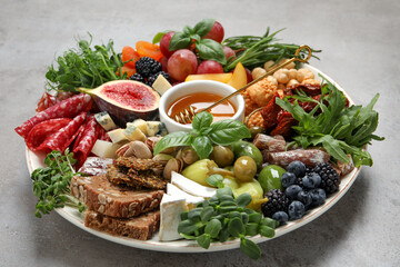 Set of different delicious appetizers served on light grey table