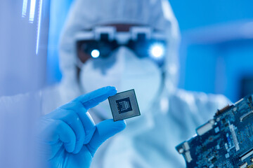 African-American scientist works in a modern scientific laboratory for the research and development of microelectronics and processors. Manufacturing worker uses computer technology and equipment.