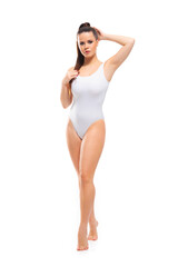 Young, fit and beautiful brunette woman in white swimsuit isolated on white background. Healthcare, diet, sport and fitness.