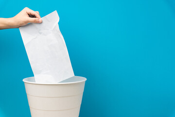 White crumpled paper beacons are thrown in the trash can.