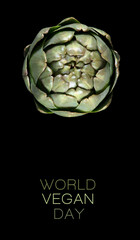 Obraz premium Conceptual design for the World Vegan day with a top view of fresh artichoke on black background. World food day. Vegetarian day